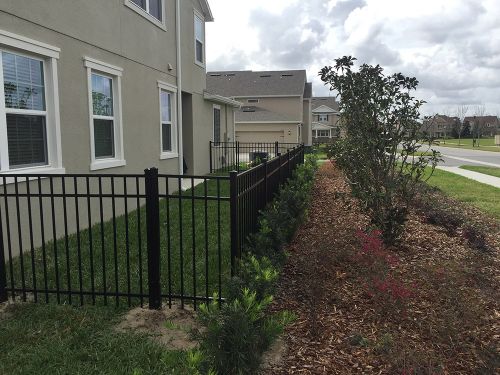 Black aluminum fence around a small yard