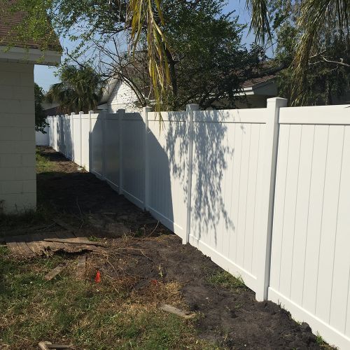 A newly installed vinyl fence