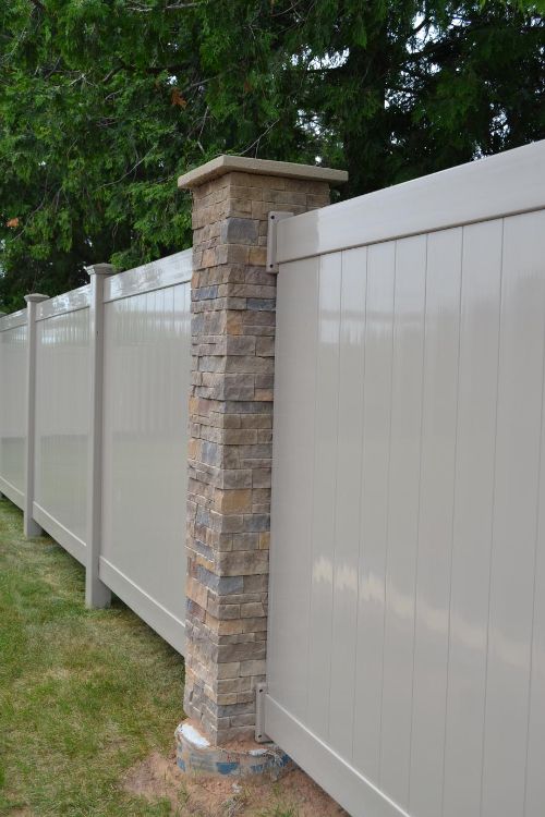 Vinyl fence attached in a stone post 