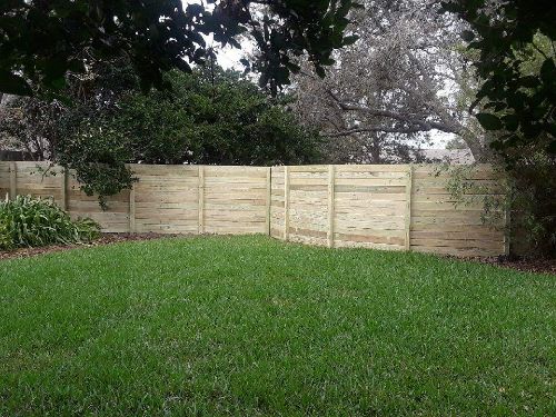 Backyard surrounded by wood fence