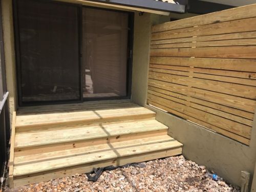 Wood fence beside home entrance